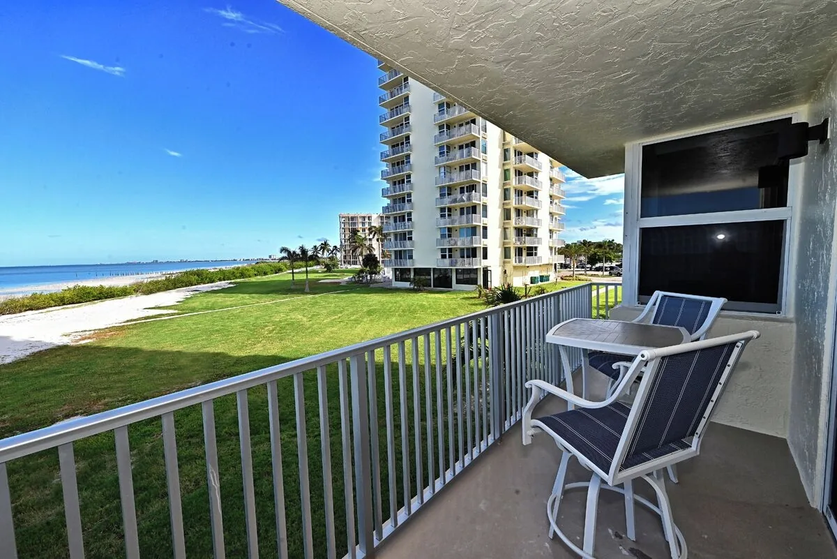 Balcony view of the ocean and grounds at Beachfront Haven