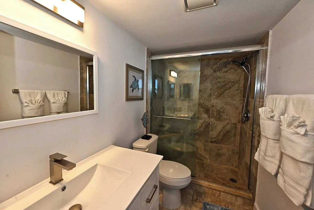 Bathroom with walk-in shower at Beachfront Haven
