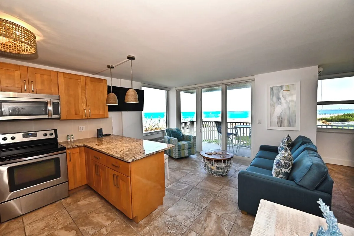 Fully equipped kitchen with ocean view at Beachfront Haven condo