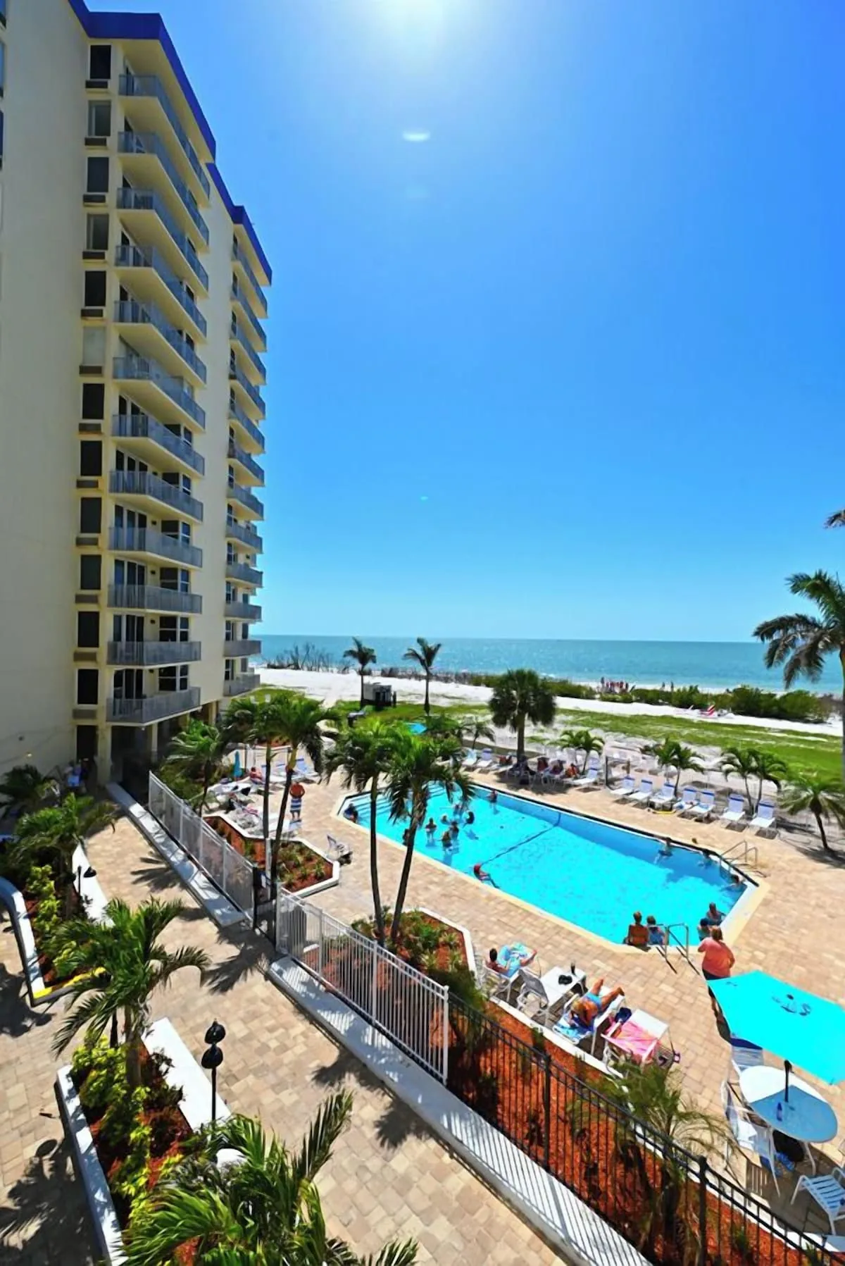 Heated pool with building balconies at Estero Beach & Tennis Club