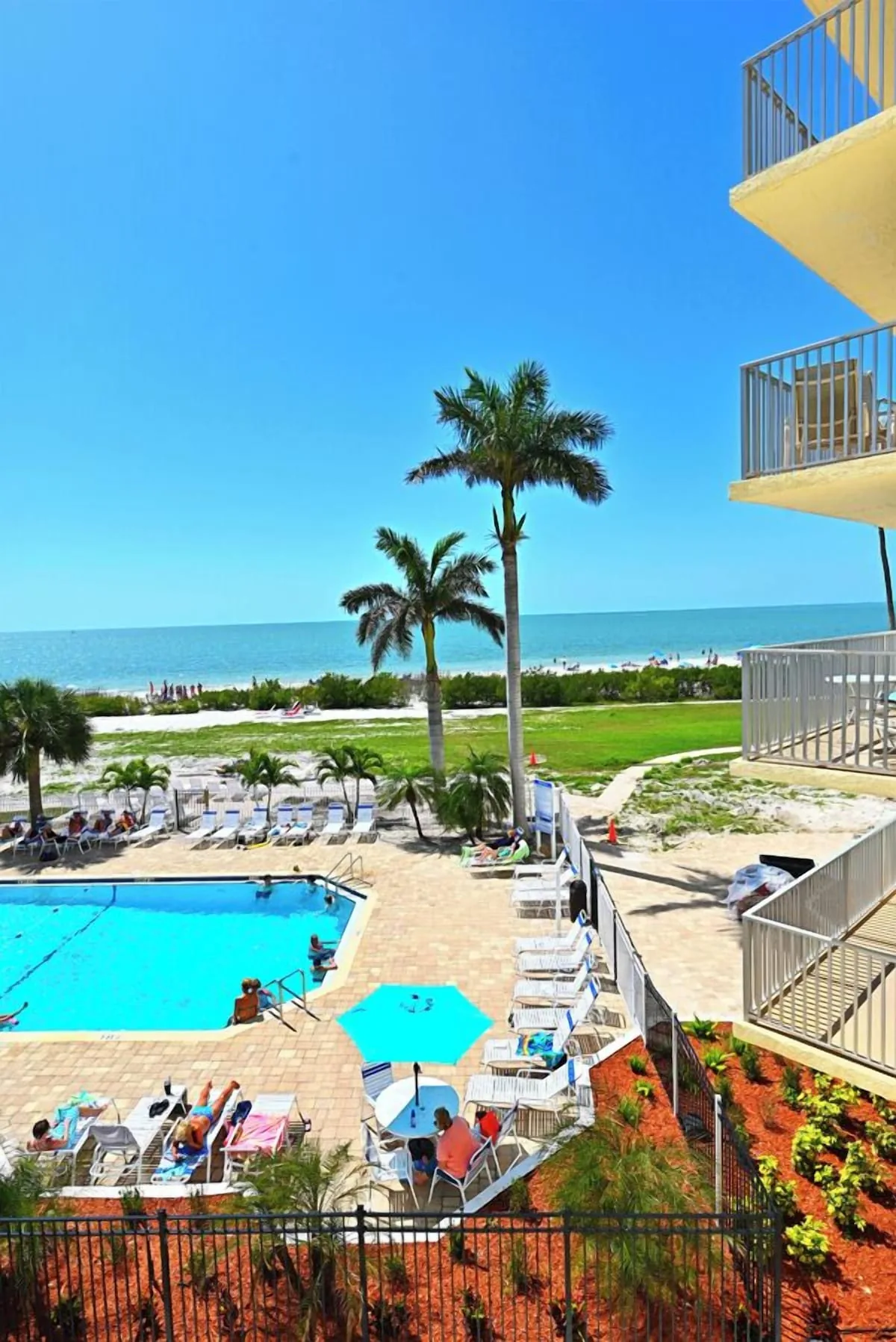 Pool loungers near the beach at Beachfront Haven