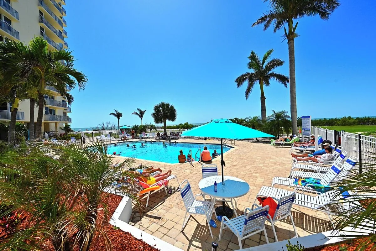 Pool loungers and umbrellas at Beachfront Haven